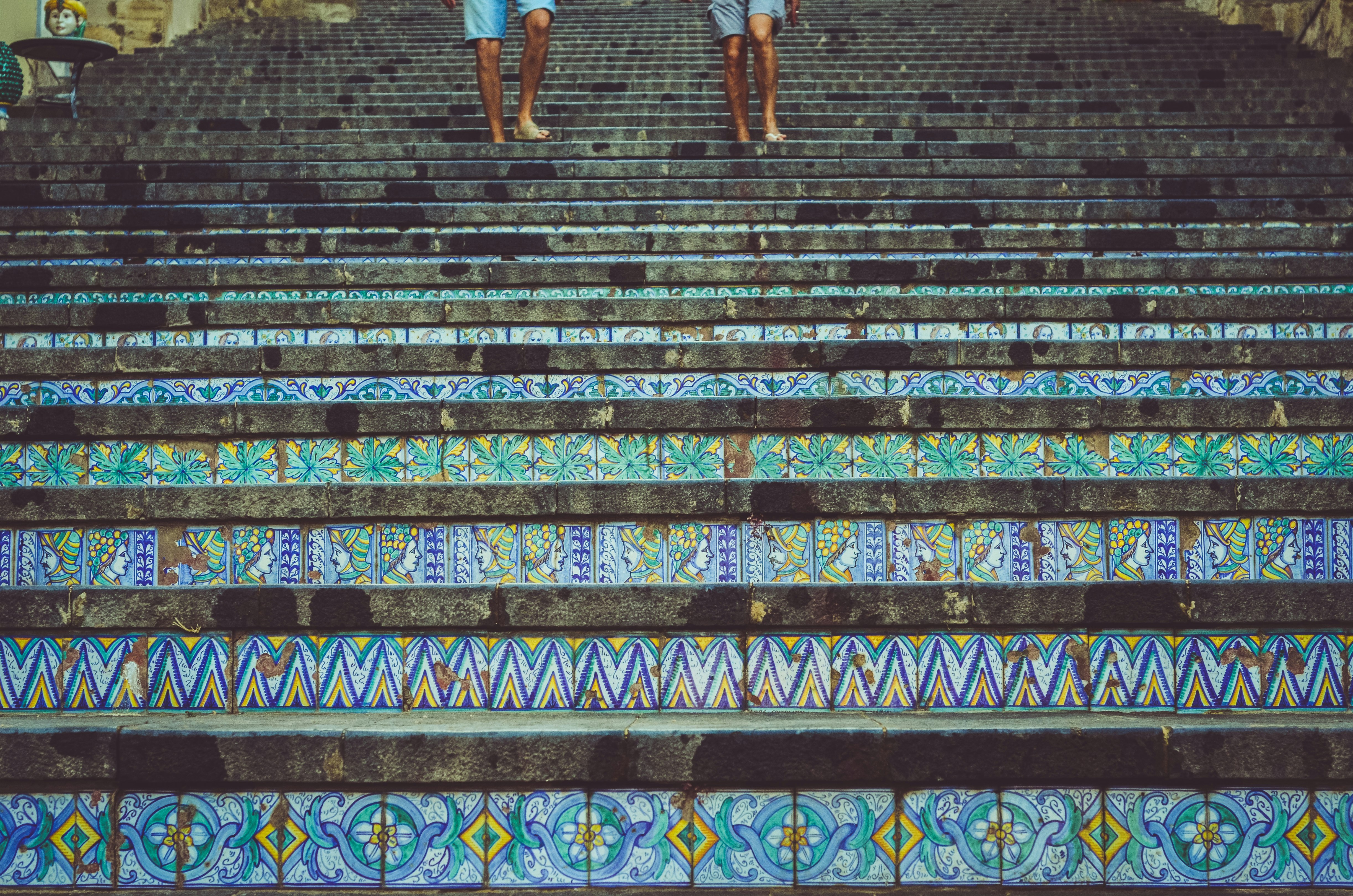 two person's stepping on stairs